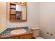 Bathroom featuring unique tile countertop, wood cabinets, and a mirrored medicine cabinet at 8602 N 39Th St, Longmont, CO 80503