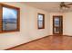 A naturally lit bedroom provides beautiful mountain views through sizable windows at 8602 N 39Th St, Longmont, CO 80503