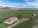 Exterior view of home and land surrounded by large open fields with mountain views at 8602 N 39Th St, Longmont, CO 80503