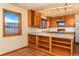 Rustic kitchen with open shelving, Saltillo tile, mountain views, and wood cabinetry at 8602 N 39Th St, Longmont, CO 80503