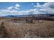 Pasture with wooden fence, mountains in the distance, and tall dry grasses in foreground at 8602 N 39Th St, Longmont, CO 80503