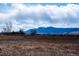 Expansive view of Colorado landscape with mountains in the background and cloudy skies at 8602 N 39Th St, Longmont, CO 80503