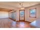 Bright living room with Saltillo tile, wood ceiling beams and multiple glass doors offering mountain views at 8602 N 39Th St, Longmont, CO 80503