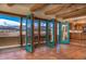 Inviting living area with turquoise French doors opening to balcony with scenic views and exposed beams at 8602 N 39Th St, Longmont, CO 80503