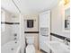 Bathroom features a shower-tub combo, storage, and neutral colors creating a calming space at 2047 S Milwaukee St # 4, Denver, CO 80210