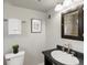 Bathroom features modern vanity with stone countertop and tiled shower in the mirror reflection at 2047 S Milwaukee St # 4, Denver, CO 80210