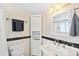 Light bathroom featuring a tiled shower-tub, cabinet storage, and a modern sink and fixtures at 2047 S Milwaukee St # 4, Denver, CO 80210