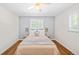 Cozy bedroom with natural light, hardwood floors, and a ceiling fan for added comfort at 2047 S Milwaukee St # 4, Denver, CO 80210