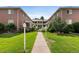 Apartment complex featuring brick buildings with manicured lawns and greenery at 2047 S Milwaukee St # 4, Denver, CO 80210