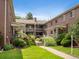Exterior shot of apartments showcasing brickwork, greenery, and walkway at 2047 S Milwaukee St # 4, Denver, CO 80210
