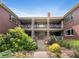 Exterior of an apartment complex with balconies, garden, and brickwork at 2047 S Milwaukee St # 4, Denver, CO 80210