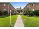 Apartment complex featuring brick buildings with manicured lawns and greenery at 2047 S Milwaukee St # 4, Denver, CO 80210