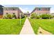 Beautiful two-story brick apartment building with lush green landscaping and a walking path at 2047 S Milwaukee St # 4, Denver, CO 80210