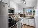 Bright kitchen featuring white cabinets, stainless steel appliances, and earth tone countertops at 2047 S Milwaukee St # 4, Denver, CO 80210