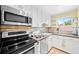 Modern kitchen features stainless steel appliances, granite counters and sleek white cabinetry at 2047 S Milwaukee St # 4, Denver, CO 80210