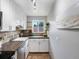Bright kitchen featuring white cabinets, a stainless steel dishwasher, and dark countertops at 2047 S Milwaukee St # 4, Denver, CO 80210