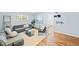 Well-lit living room featuring hardwood floors, a gray couch, and plenty of space for relaxation at 2047 S Milwaukee St # 4, Denver, CO 80210