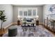 Inviting living room showcasing hardwood floors, modern decor, and a window with white shutters at 2047 S Milwaukee St # 4, Denver, CO 80210