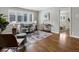 Sunlit living room boasts hardwood floors, neutral décor, and bright window with white shutters at 2047 S Milwaukee St # 4, Denver, CO 80210