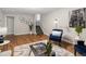 Hardwood floors lead to stairs in the living room with gray paint and modern furnishings at 2047 S Milwaukee St # 4, Denver, CO 80210
