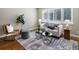 Bright living room featuring hardwood floors, area rug, and a comfortable seating arrangement at 2047 S Milwaukee St # 4, Denver, CO 80210