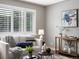 Bright living room features a white sofa, stylish decor, and shuttered windows for ample light at 2047 S Milwaukee St # 4, Denver, CO 80210