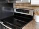 Stainless steel stove top in kitchen features black cook top and digital display at 2047 S Milwaukee St # 4, Denver, CO 80210