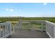 A clear view of the home's back deck and the green fields that stretch into the distance at 8819 Sedalia St, Commerce City, CO 80022