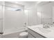 Bright, tiled bathroom featuring a tub, shower, toilet, and modern sink with chrome fixtures at 8819 Sedalia St, Commerce City, CO 80022