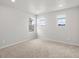 Neutral bedroom with carpet, three windows, and recessed lighting providing bright, natural light at 8819 Sedalia St, Commerce City, CO 80022