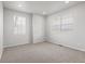 Bright bedroom with carpet flooring and two windows with blinds at 8819 Sedalia St, Commerce City, CO 80022
