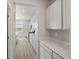 Hallway view into kitchen with light gray cabinets and countertops at 8819 Sedalia St, Commerce City, CO 80022