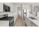 A bright kitchen featuring modern stainless steel appliances and light gray cabinetry at 8819 Sedalia St, Commerce City, CO 80022