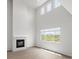 Bright living room with high ceilings, fireplace, large windows and views of open land at 8819 Sedalia St, Commerce City, CO 80022