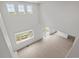 Open living room with tall ceilings, light wood floors, and multiple large windows with a backyard view at 8819 Sedalia St, Commerce City, CO 80022