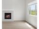 Living room with decorative fireplace and a large window with a view at 8819 Sedalia St, Commerce City, CO 80022