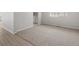 Open-concept living room features a carpet area next to wood-look flooring at 8819 Sedalia St, Commerce City, CO 80022