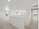 A bright and spacious loft area with neutral carpet, recessed lighting, and white walls at 8819 Sedalia St, Commerce City, CO 80022