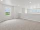 Open loft area featuring plush carpet, recessed lighting, and large windows with views of the outside at 8819 Sedalia St, Commerce City, CO 80022