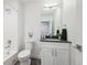 Clean bathroom with a white vanity, toilet and shower/tub combo at 5232 Columbine Ln, Denver, CO 80221