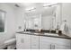 Bathroom boasts double vanity, modern fixtures, and large mirror at 5232 Columbine Ln, Denver, CO 80221