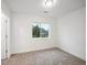 Bright bedroom with carpet flooring and a view from the window at 5232 Columbine Ln, Denver, CO 80221