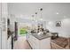 Modern kitchen with island and stainless steel appliances, open to living room at 5232 Columbine Ln, Denver, CO 80221