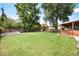 Spacious backyard featuring lush green grass and a play set for outdoor fun at 585 Estes St, Lakewood, CO 80226