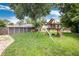 Large backyard with a play set and storage shed, perfect for Gathering activities and storage at 585 Estes St, Lakewood, CO 80226