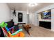 Finished basement featuring neutral carpet, workout station, entertainment center, and colorful rocking chair at 585 Estes St, Lakewood, CO 80226