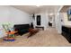 Spacious basement with a black futon, bench, colorful rocking chair, and wood sled on neutral carpet at 585 Estes St, Lakewood, CO 80226