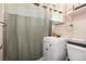 Cozy bathroom featuring a shower with chevron pattern curtain and modern vanity and sink at 585 Estes St, Lakewood, CO 80226