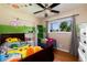 Colorful bedroom featuring a ceiling fan, natural light and custom shelving at 585 Estes St, Lakewood, CO 80226