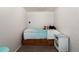 Modest bedroom with neutral carpet, single bed, small dresser, and simple décor at 585 Estes St, Lakewood, CO 80226